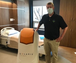 nurse posing with disinfectant machine